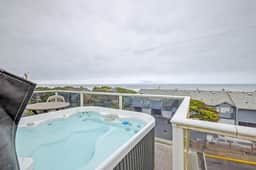 Luxury home with hot tub overlooking the beach and game room