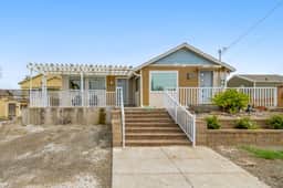 Light filled home in the heart of town with deck and with D steps to beach access