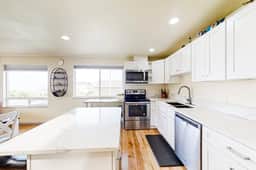 Light filled home in the heart of town with deck and with D steps to beach access