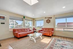Light filled home in the heart of town with deck and with D steps to beach access