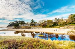 Creekside condo with beach access balcony full kitchen and ocean views