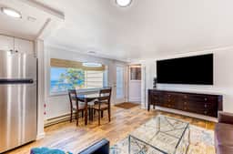 Quaint ocean view escape with modern interior smart TV and gorgeous deck