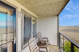 Beachfront condo boasting beautiful views a private balcony and perfect location
