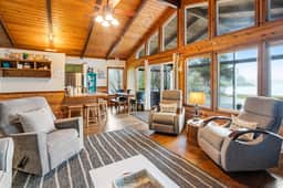 Rustic waterfront woodland lodge with impressive lake views from patio