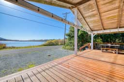 Rustic waterfront woodland lodge with impressive lake views from patio - Image 4