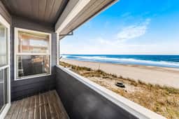 Two story oceanfront retreat with a washer dryer firepit and Ping Pong table