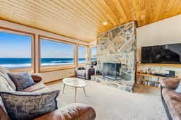 Two story oceanfront retreat with a washer dryer firepit and Ping Pong table