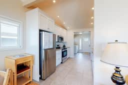 Beachfront home with ocean facing deck and ocean views throughout modern kitchen - Image 5
