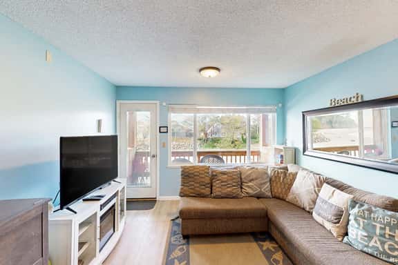 Creekside condo with beach access balcony full kitchen and ocean views - Image 1