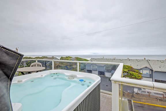 Luxury home with hot tub overlooking the beach and game room