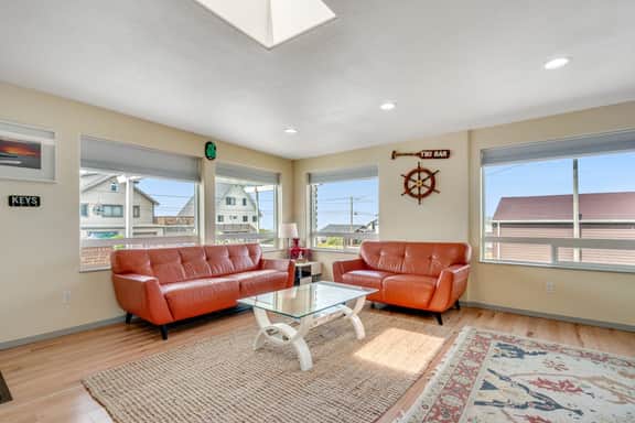 Light filled home in the heart of town with deck and with D steps to beach access