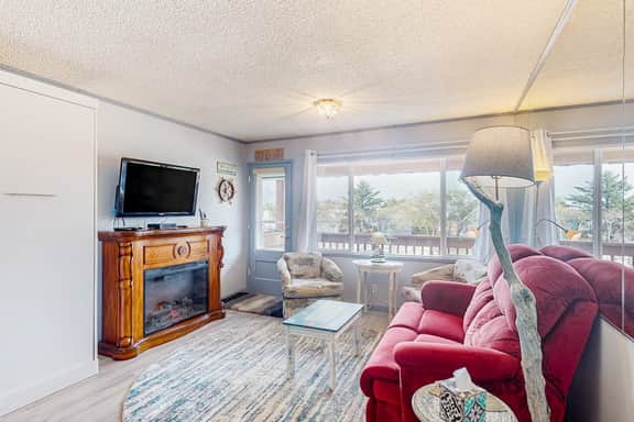 Cozy Coastal Condo Steps from the Beach with Deck Views