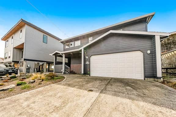 Two story oceanfront retreat with a washer dryer firepit and Ping Pong table