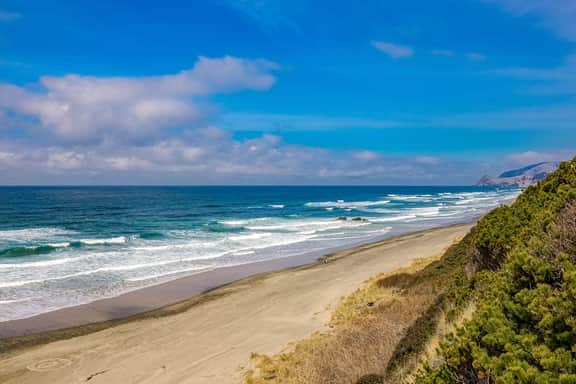 Ocean view home 1 block from the beach with hot tub deck and fireplace
