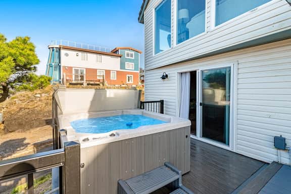 Bright home with stunning ocean views private hot tub and nearby beach access